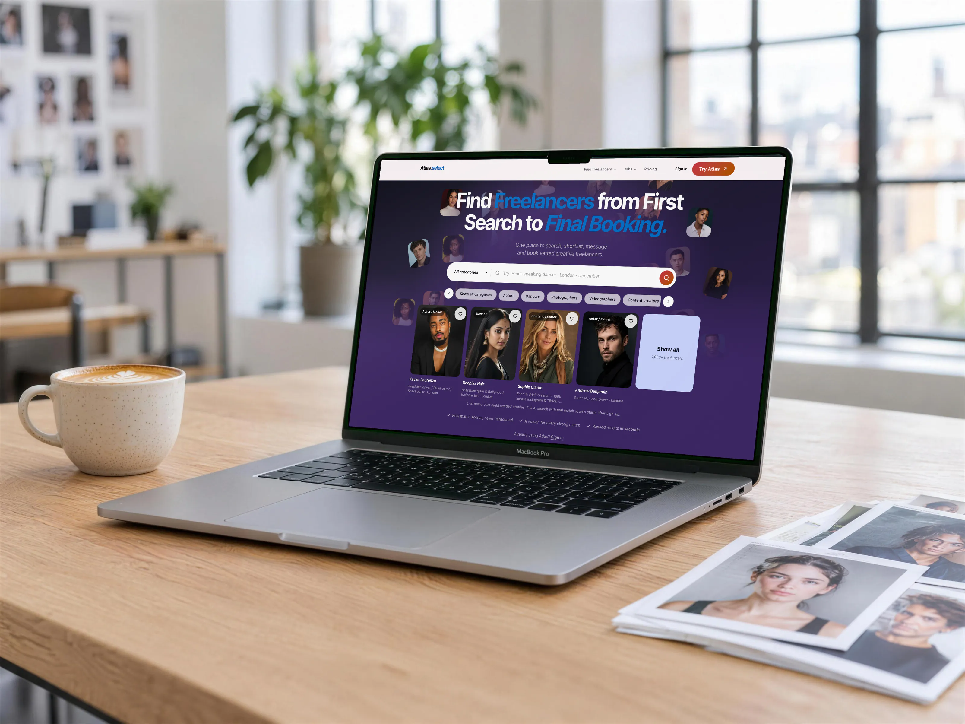 Atlas freelancer booking web app on a MacBook Pro in a creative studio