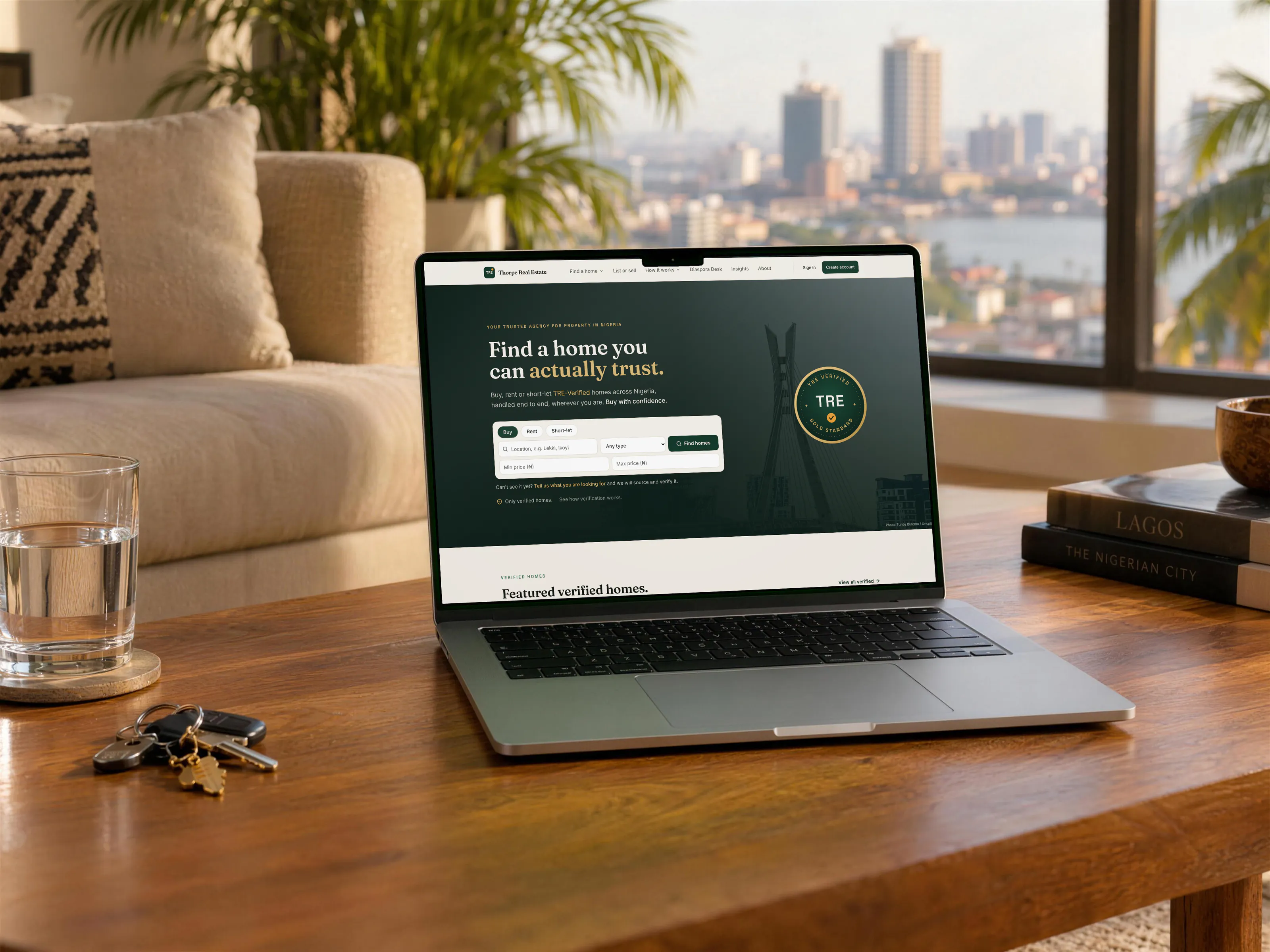 Thorpe Real Estate website on a MacBook Pro in a sunlit living room